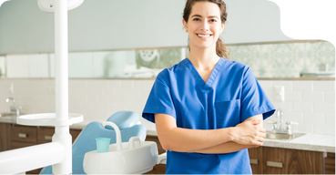 Smiling dental team member standing in a treatment room